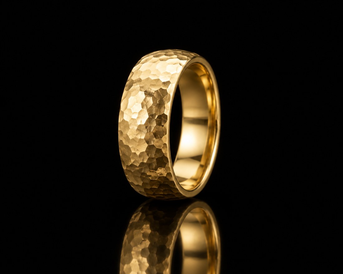 Wide hand-hammered wedding band in yellow gold